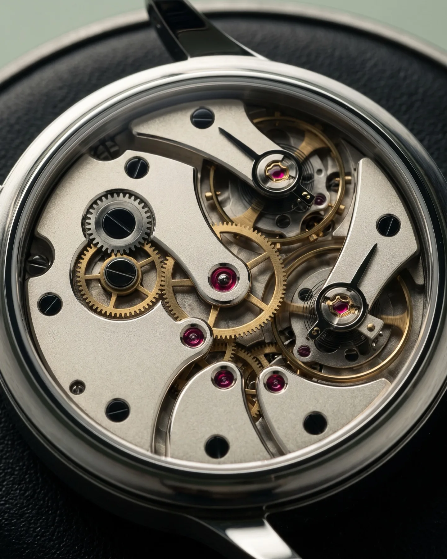 Reverse of calibre T/01 showing removable German-silver bridges, brass train wheels and polished steel fittings.